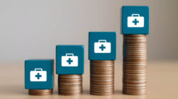 Stacked coins with healthcare icons representing rising employee health plan costs over time