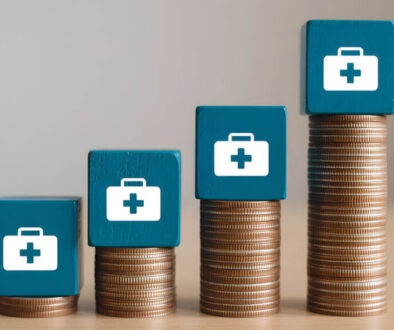 Stacked coins with healthcare icons representing rising employee health plan costs over time